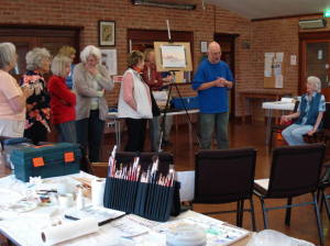 Stephen Martyn discusses watercolour with students at a painting workshop