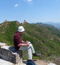 Photo of Stephen Martyn sketching on the Great Wall of China